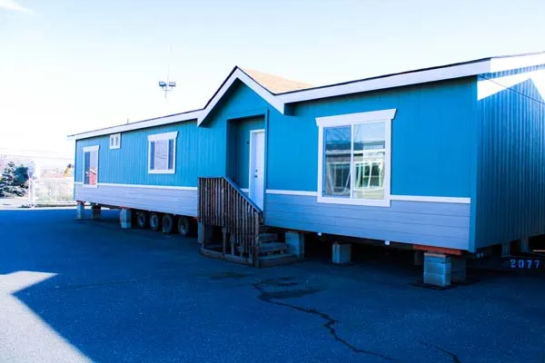 A multi-section home set on blocks at our lot